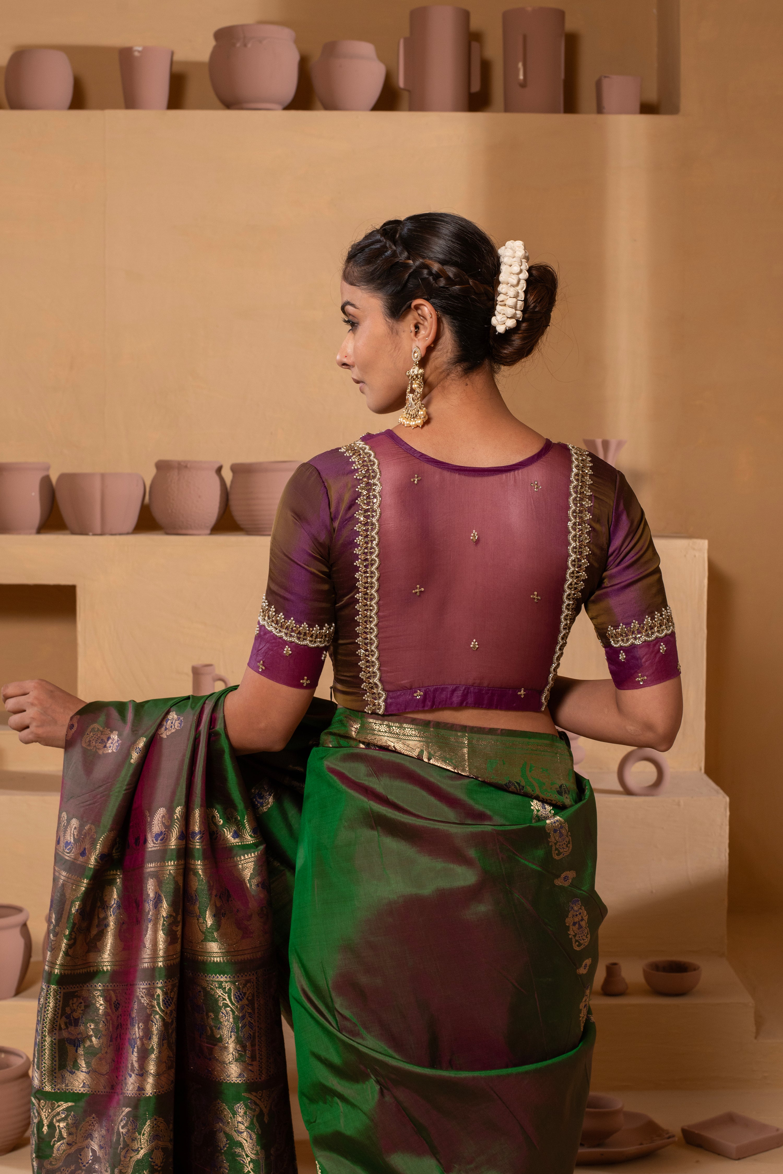 Silk blouse with embroidery on the neckline and sleeves, with a stylish, detailed back design