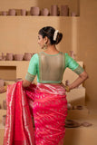 Silk blouse with intricate embroidery on the sleeves and back, showcasing exquisite craftsmanship.