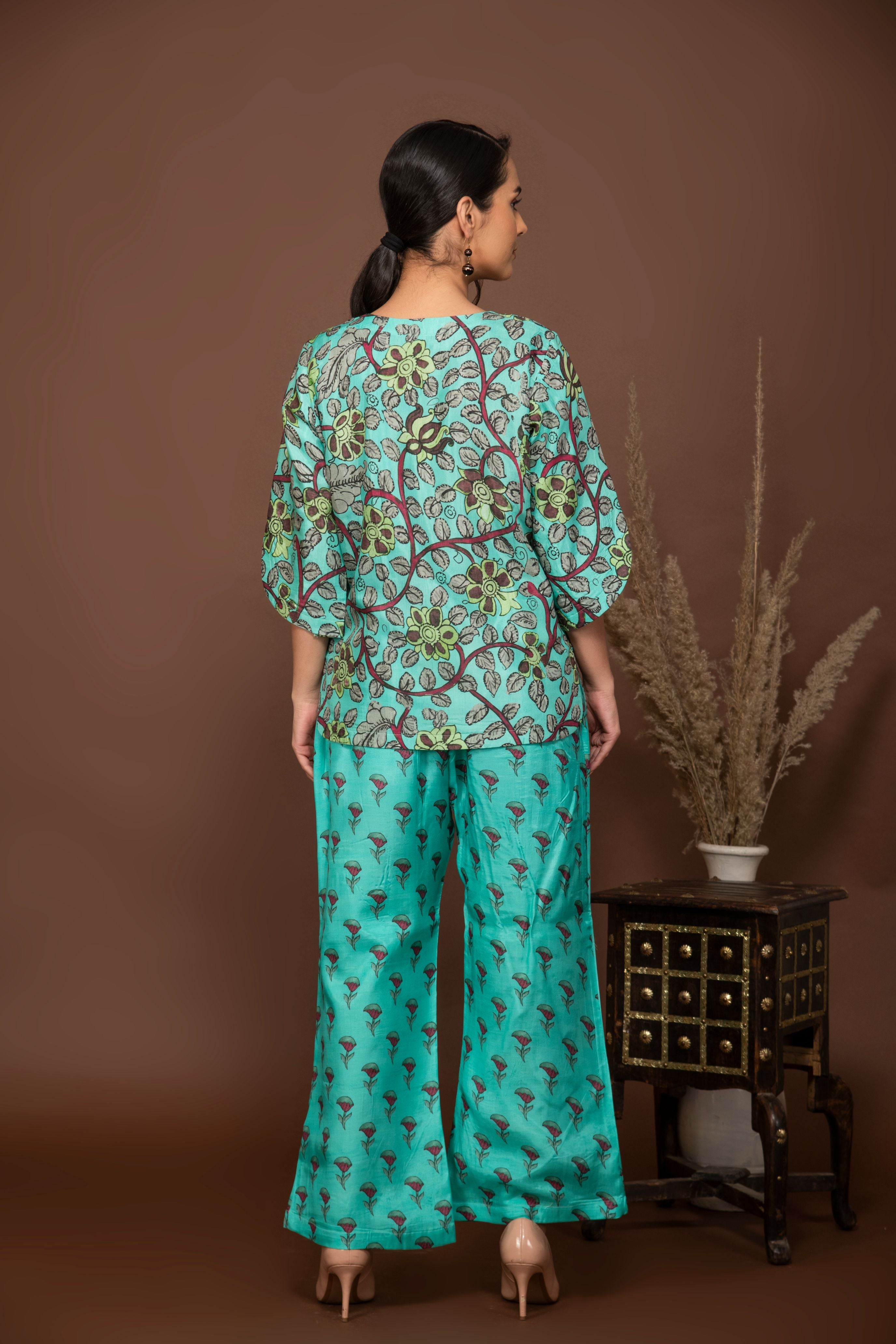 Blue soft muslin floral printed top with flower butti printed all over bottom.