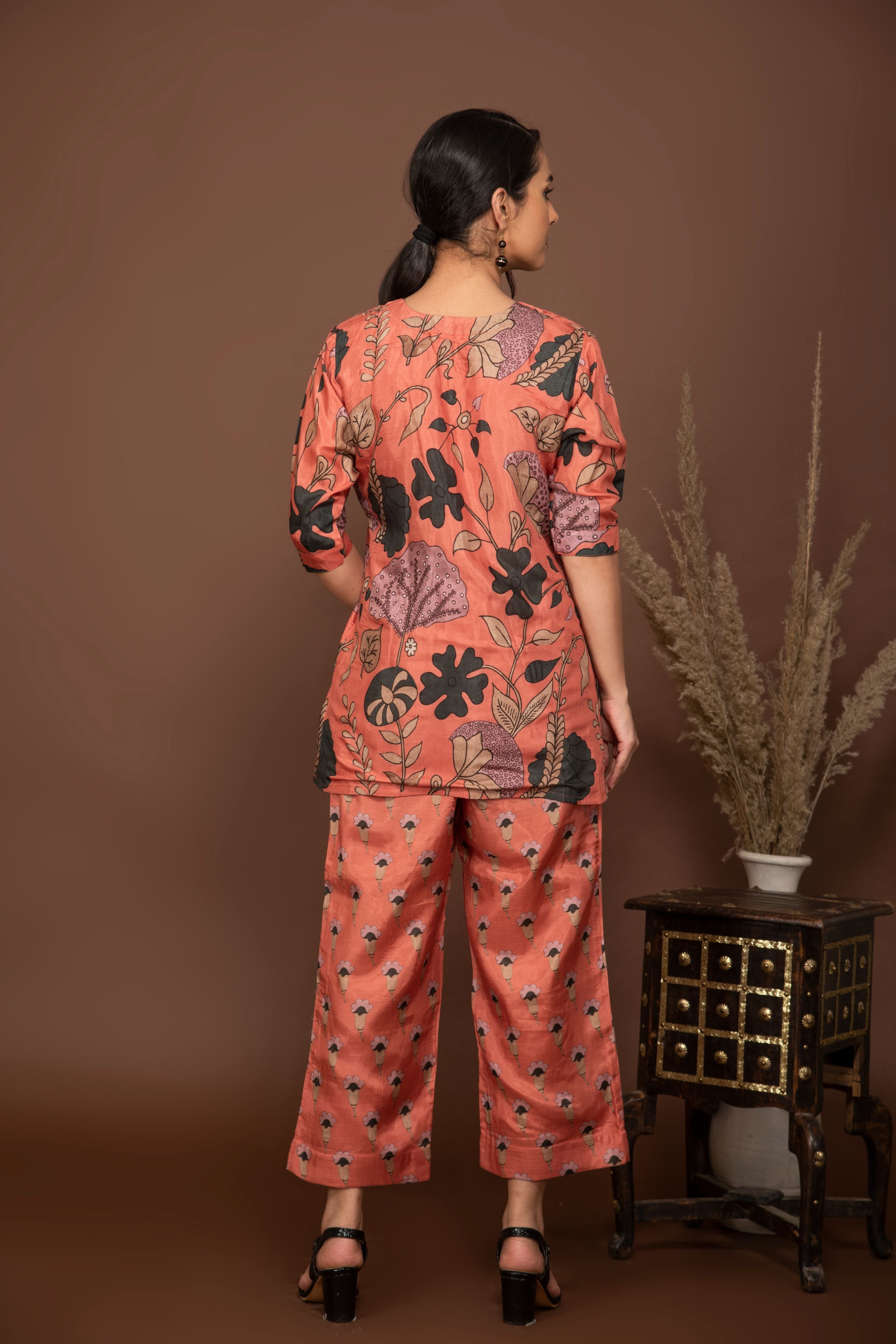 Peach soft muslin with bold flower printed top with butti printed bottom.