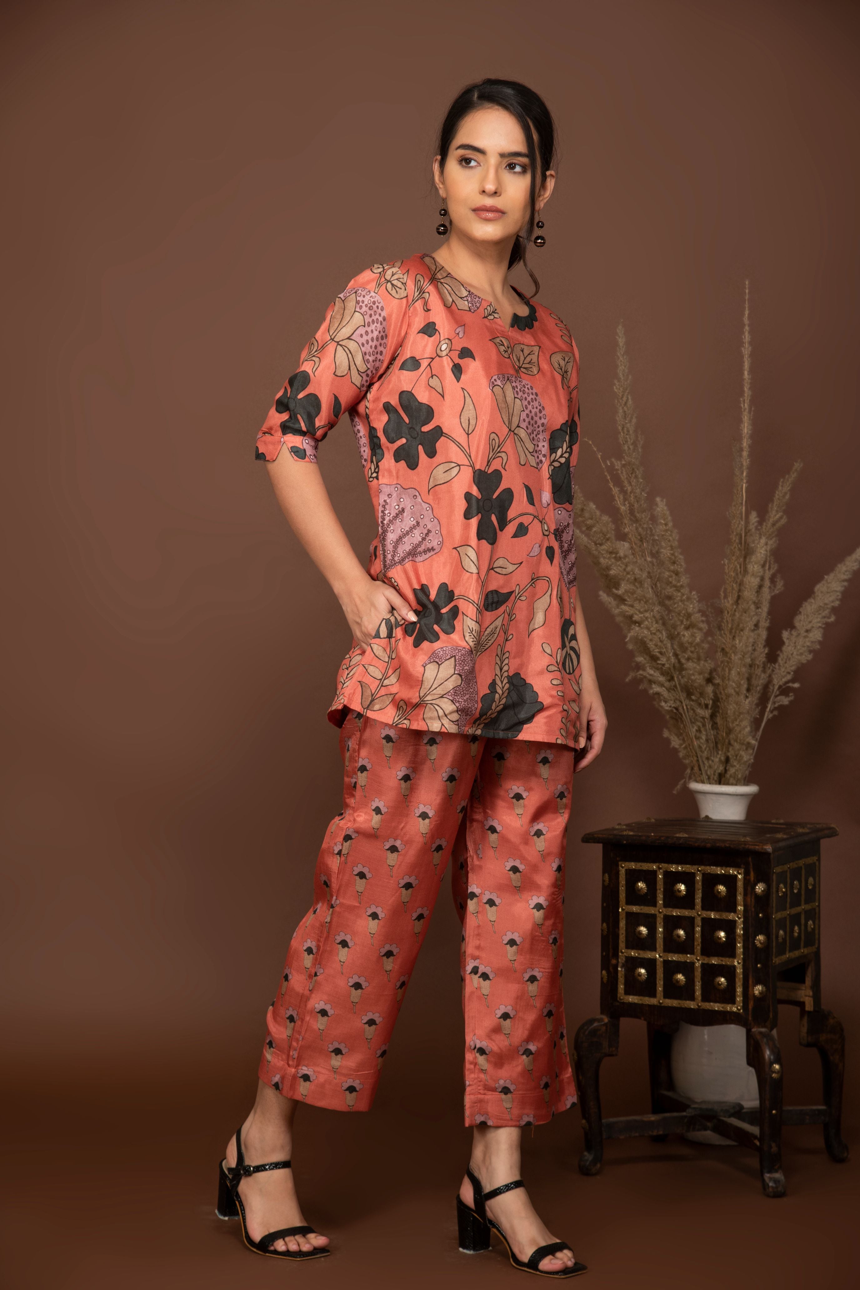 Peach soft muslin with bold flower printed top with butti printed bottom.