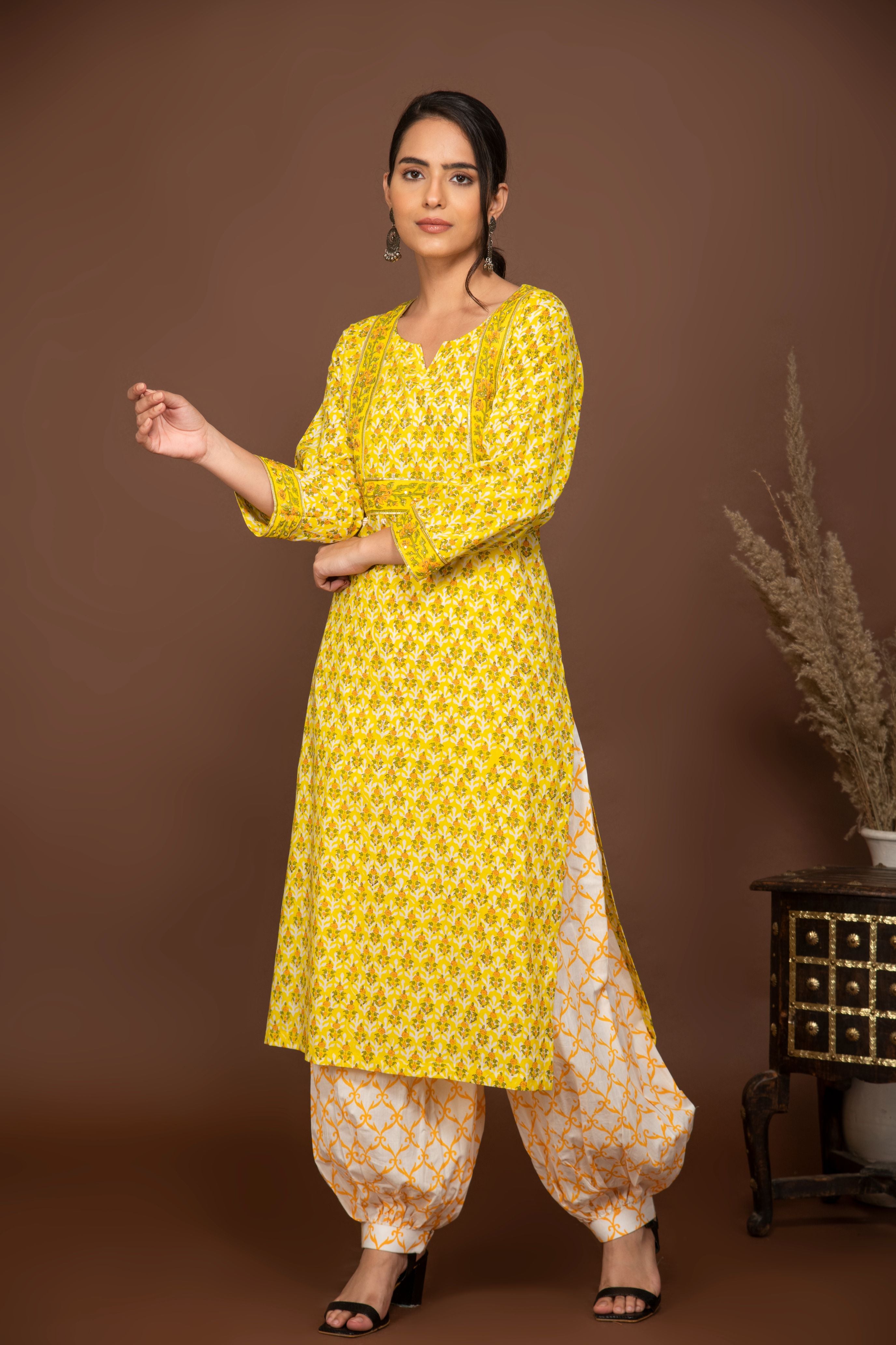 Yellow floral printed kurta with white/mustard printed bottom 3 piece suit set with printed buttis all over dupatta.