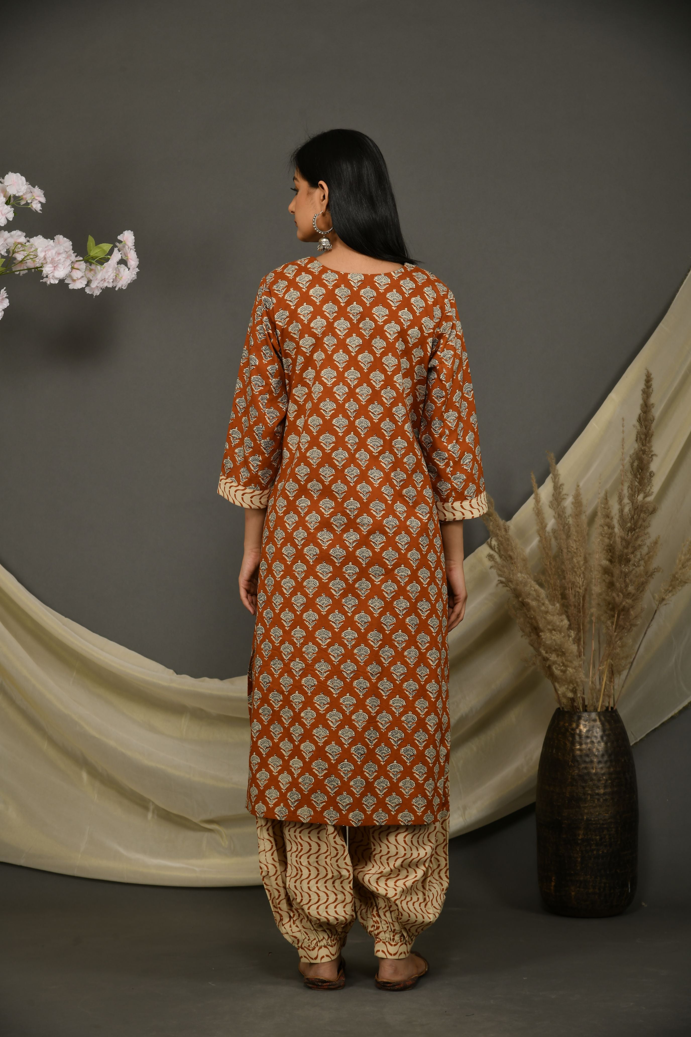 Rusted brown cotton jaipuri printed kurta with beige printed pants and dupatta.