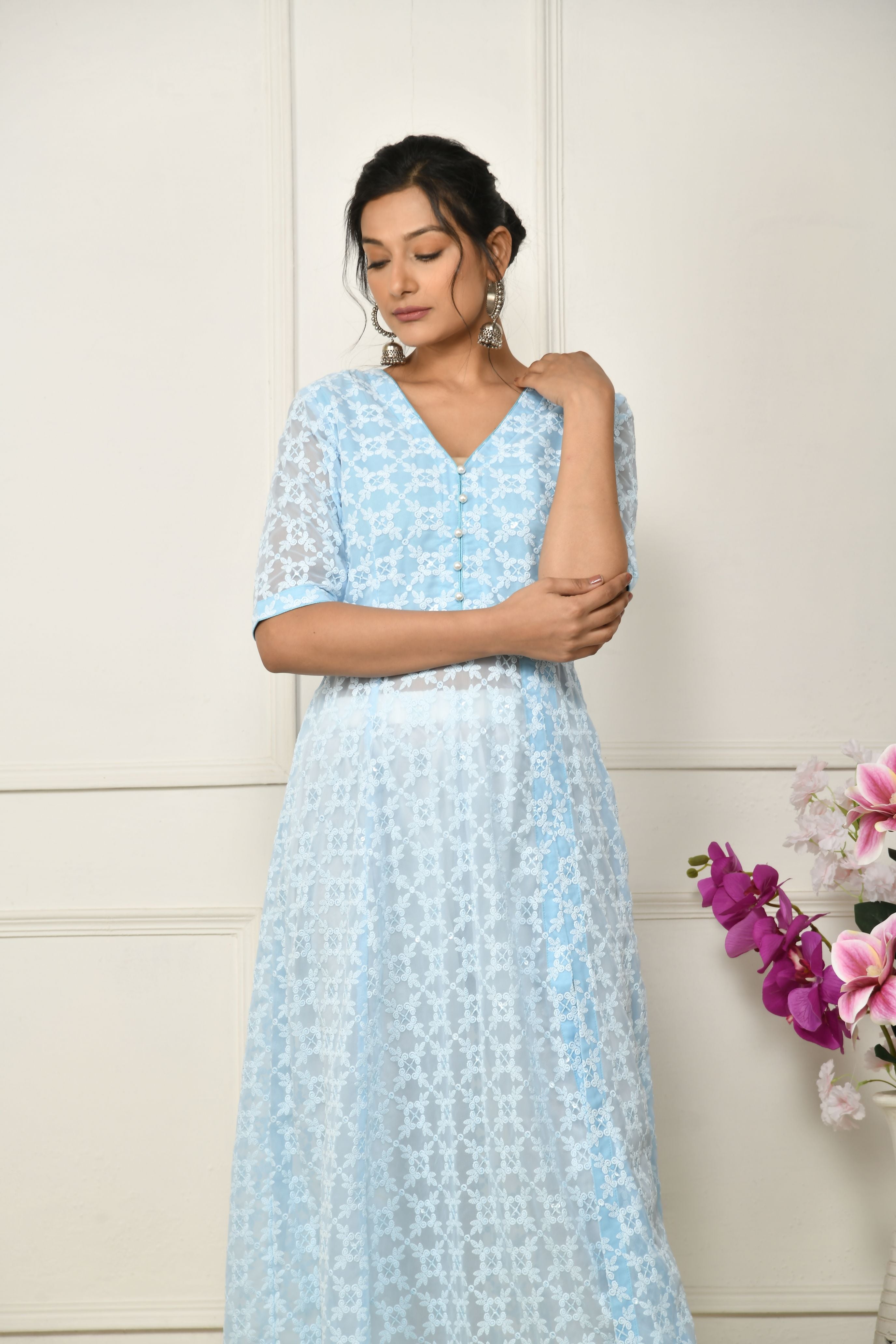 Blue georgette thread embroidered flared top with a front slit and a yoke lining .â 