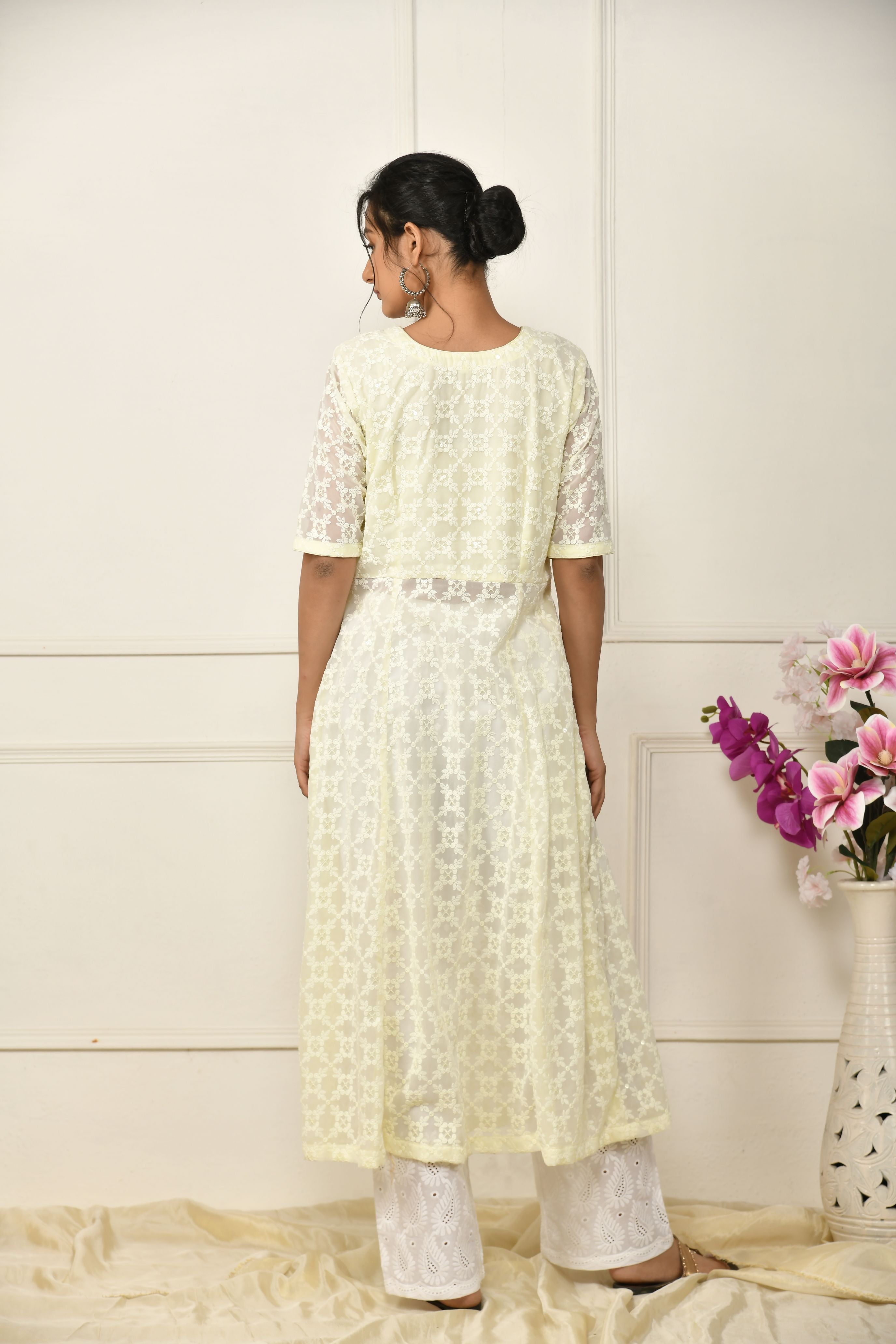 Lemon yellow georgette thread embroidered flared top with a front slit and a yoke lining