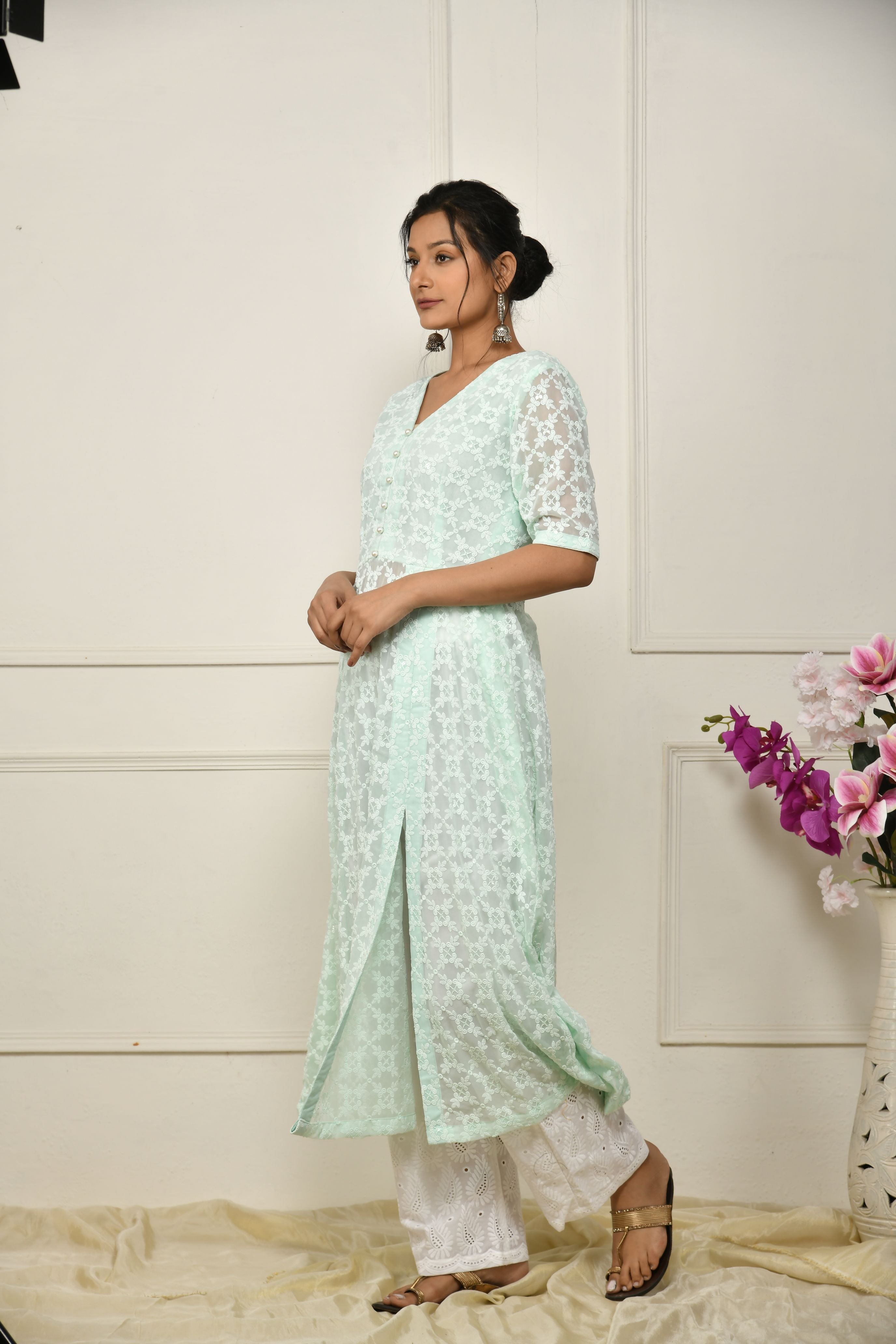 Green georgette thread embroidered flared top with a front slit and a yoke lining